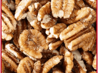 Close-up image of a pile of Southern roasted pecans. The top features a red banner with the text Roasted Pecans and a website link in white font. The bottom left corner showcases a logo with a dog and three boys, all hinting at the wholesome family recipe behind these delicious snacks.