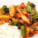A plate of Easy Chinese Stir-Fry with tender chicken, broccoli, carrots, and peas in a savory sauce over white rice. The text reads Quick & Easy Recipe alongside a logo at the bottom.