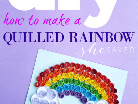 A colorful quilled rainbow art project on light blue paper with green grass at the end of the rainbow, set against a purple backdrop. Text reads: DIY how to make a quilled rainbow she saved Easy!.