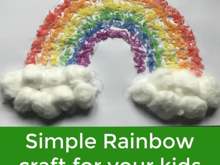 A colorful rainbow craft made from rice and cotton balls is displayed. The rainbow arcs from left to right with fluffy clouds at the end of the rainbow. A green banner below reads, Simple Rainbow craft for your kids.