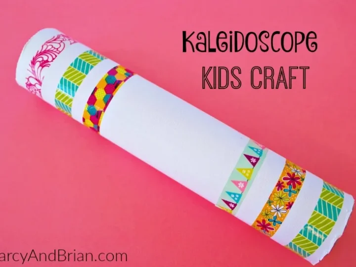 A homemade kaleidoscope craft, adorned with vibrant floral, chevron, and geometric tape designs, pops against a bright pink background. Text reads Kaleidoscope Kids Craft and DarcyAndBrian.com. Celebrate National Craft Month with endless crafty ideas!.