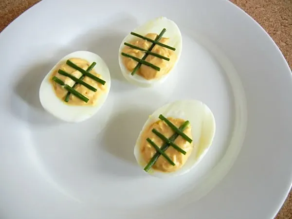 Tailgating Deviled Eggs. Make your deviled eggs look like footballs! This recipe has some spice. Get the recipe at 3 Boys & a Dog! It's the Ultimate Tailgating Party!