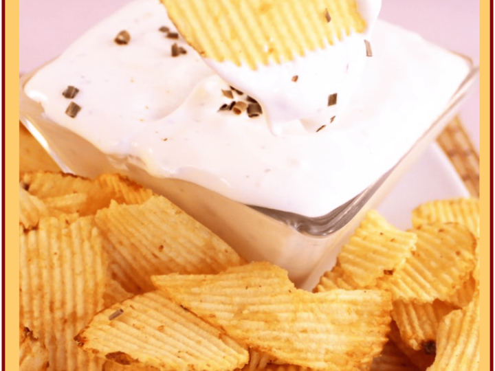 A bowl of sour cream and onion dip is surrounded by crinkle-cut potato chips. A hand holds a chip dipped in the creamy mixture. Text reads Sour Cream and Onion Dip: Super Easy & Delicious.