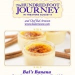 Advertisement for The Hundred-Foot Journey, showcasing Bals Banana Cardamom Crème Brûlée. Three ramekins with caramelized tops are centered, with cinnamon sticks in the background. Release date: August 8. Chef Bal Arneson is mentioned.