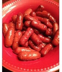A red bowl brimming with glazed cocktail sausages offers a delectable taste of a Simple Smokies Recipe.