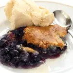 This Blueberry Cake Mix Cobbler Recipe is a favorite eaten almost right out of the oven AND it makes the entire house smell so delicious!