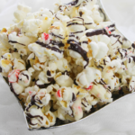 popcorn with peppermint bark and chocolate drizzle