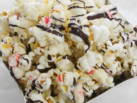 popcorn with peppermint bark and chocolate drizzle