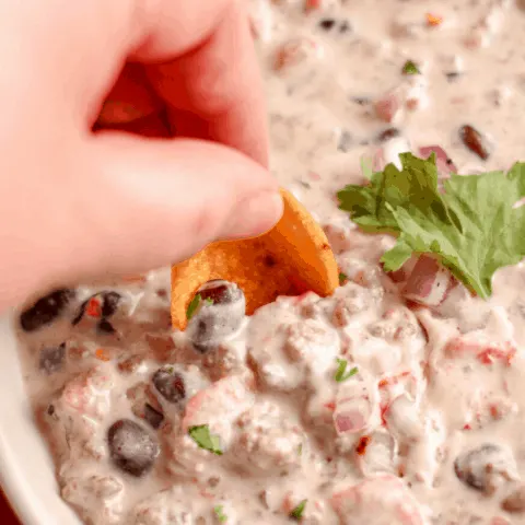 ground beef and cheese combine with beans for a delicious dip recipe