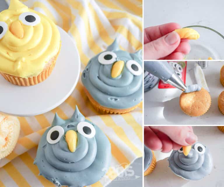 Two owl-themed cupcakes adorned with blue frosting and candy eyes come to life as a hand demonstrates how to make Owl Cupcakes. One boasts yellow beak details, while fondant beaks are shaped and piped onto the cupcakes. Underneath, a striped cloth adds charm.