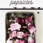 pin image that reads blueberry cheesecake popsicles with a sheet pan of frozen popsicles