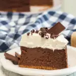 pin image that reads smores cheesecake easy dessert with a slice of cheesecake on a white plate