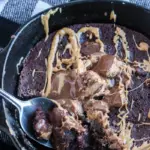 pin image that reads cookie skillet easy dessert with a picture of cookie skillet with peanut butter drizzled on top