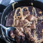 skillet cookie with a spoon taking out a scoop