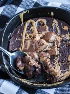 skillet cookie with a spoon taking out a scoop