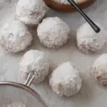 pin image that reads donut holes easy breakfast with powdered sugar donut holes on the table