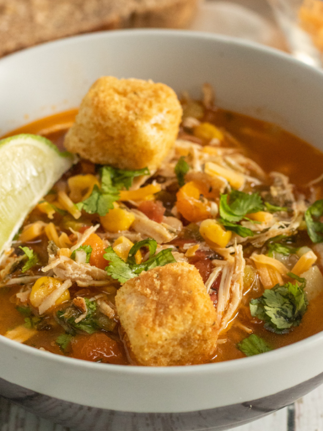 bowl of chicken soup with croutons on top
