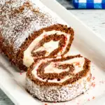 pin image that reads peppermint cake easy dessert with chocolate rolled cake on a white platter