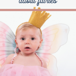 A baby girl in a pink dress, gold crown, and fairy wings sits against a white background. The text Fairy Quotes for Baby Girl adorns the top, adding a whimsical touch to this enchanting scene.