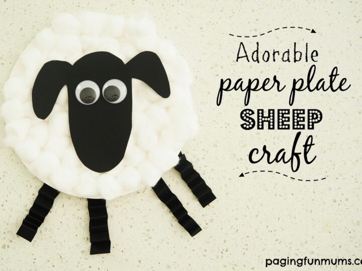 A paper plate sheep craft made with cotton balls, black paper cutouts for the head and legs, googly eyes, and clothespins. Text reads: Adorable paper plate sheep craft with the website pagingfunmums.com.