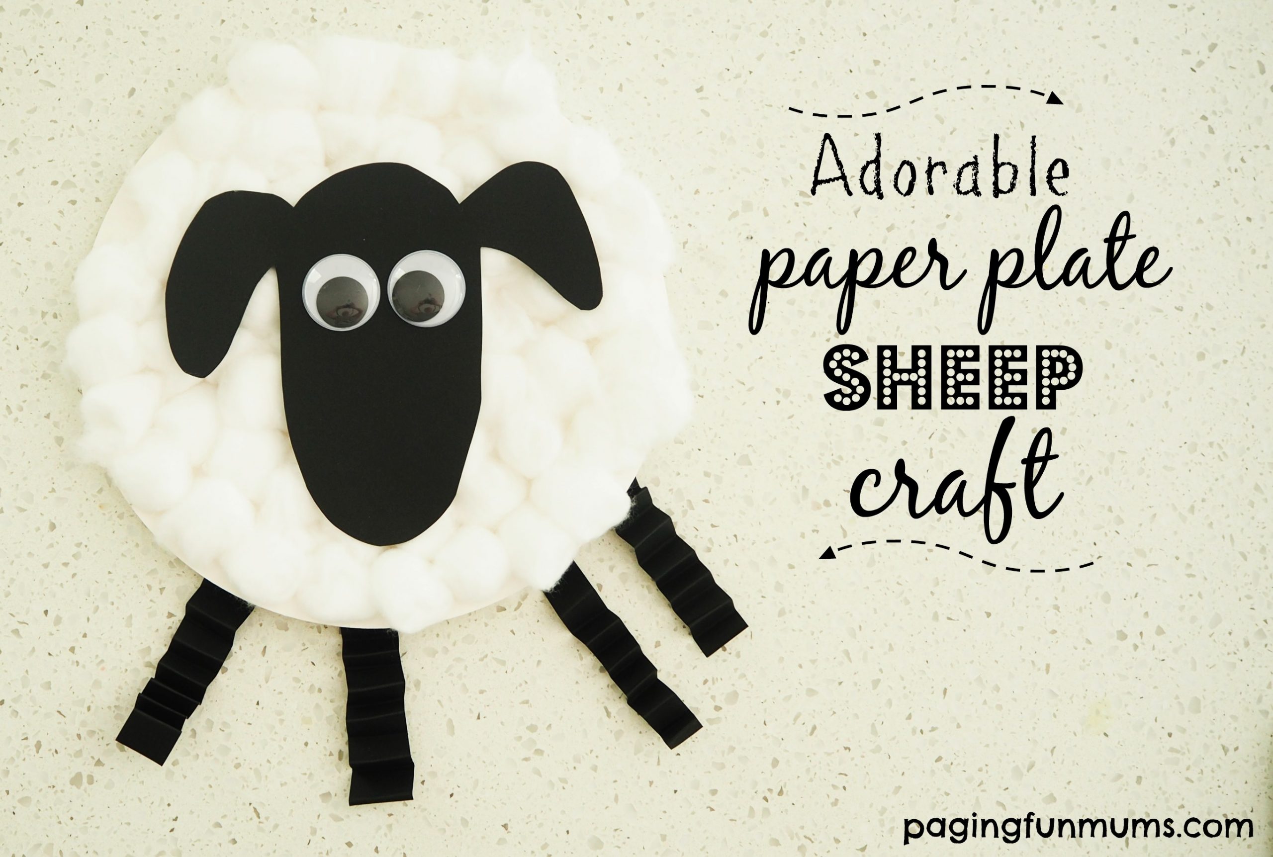 A paper plate sheep craft made with cotton balls, black paper cutouts for the head and legs, googly eyes, and clothespins. Text reads: Adorable paper plate sheep craft with the website pagingfunmums.com.