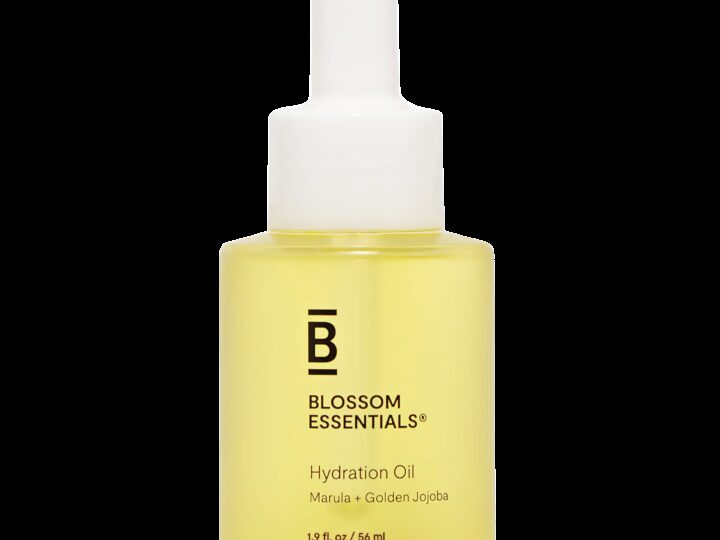 A bottle of Blossom Essentials Hydration Oil with Marula and Golden Jojoba. It has a dropper cap and contains 1.9 fl oz (56 mL) of yellow oil.