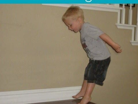 A young boy is jumping from a table indoors. The text above reads Ocean Animal Movement Game.