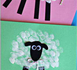 Two handmade sheep crafts on pink and green backgrounds. Each sheep has a black paper face and legs, with a body made from white fingerprints. A small bow is attached to each sheeps neck. Text on the image reads Fingerprint Sheep.