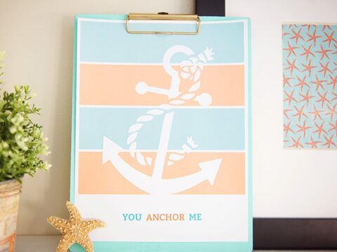 A decorative clipboard features an illustration of an anchor with rope against a striped blue and peach background. The text You Anchor Me is below. A small starfish embellishment rests nearby.