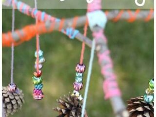 A colorful handmade mobile made from pinecones and beads hanging from branches wrapped in colorful string. The text above reads, Bead & Pinecone Mobiles.