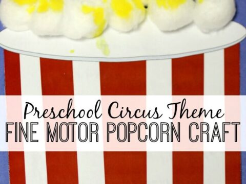 A craft project depicting a popcorn bucket with red and white stripes. The top is filled with cotton balls painted to look like popcorn. Text reads Preschool Circus Theme Fine Motor Popcorn Craft.