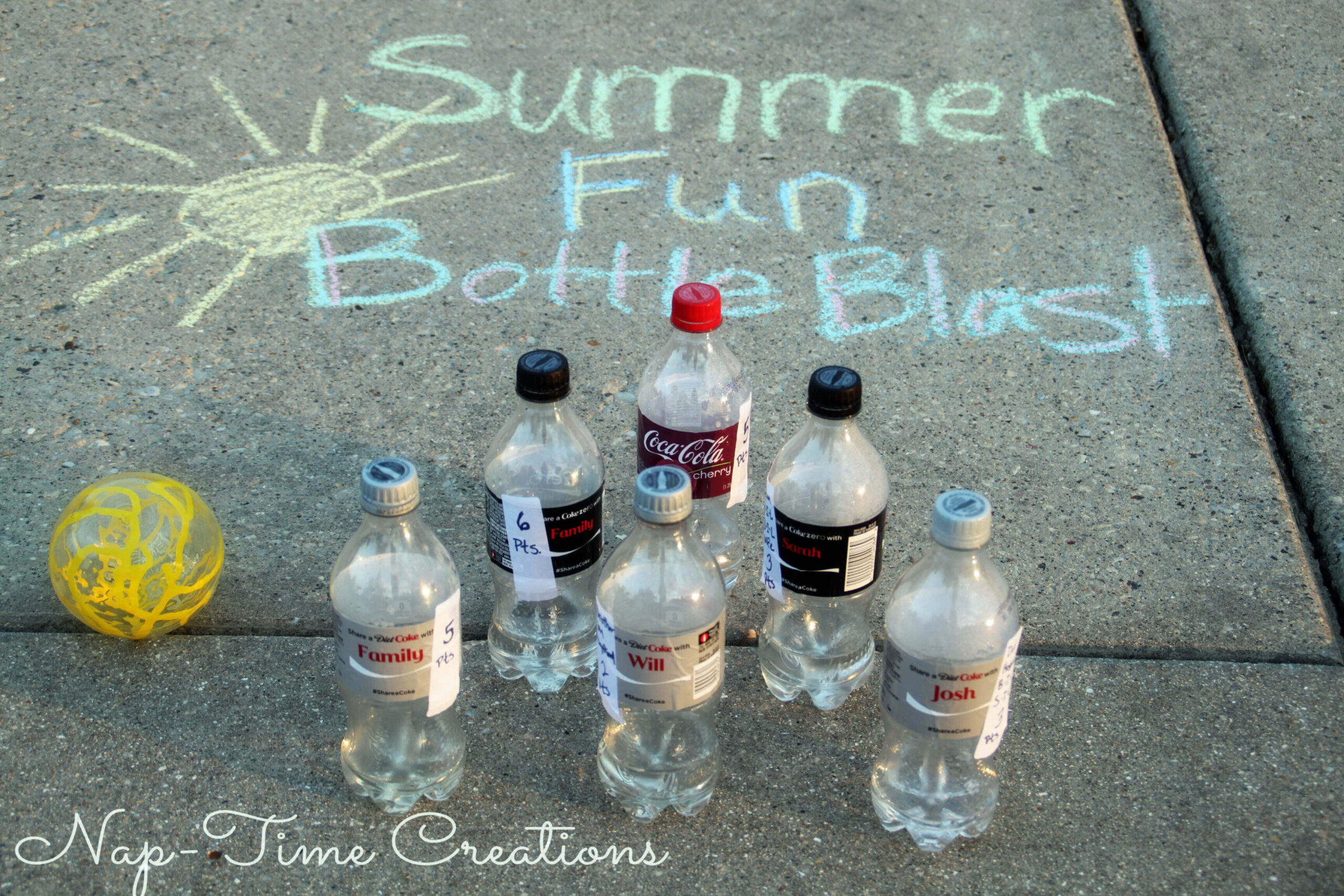 A sidewalk display titled Summer Fun Bottle Blast in chalk features six empty plastic bottles arranged in a triangle, with a yellow perforated ball nearby. The text Nap-Time Creations is visible at the bottom.