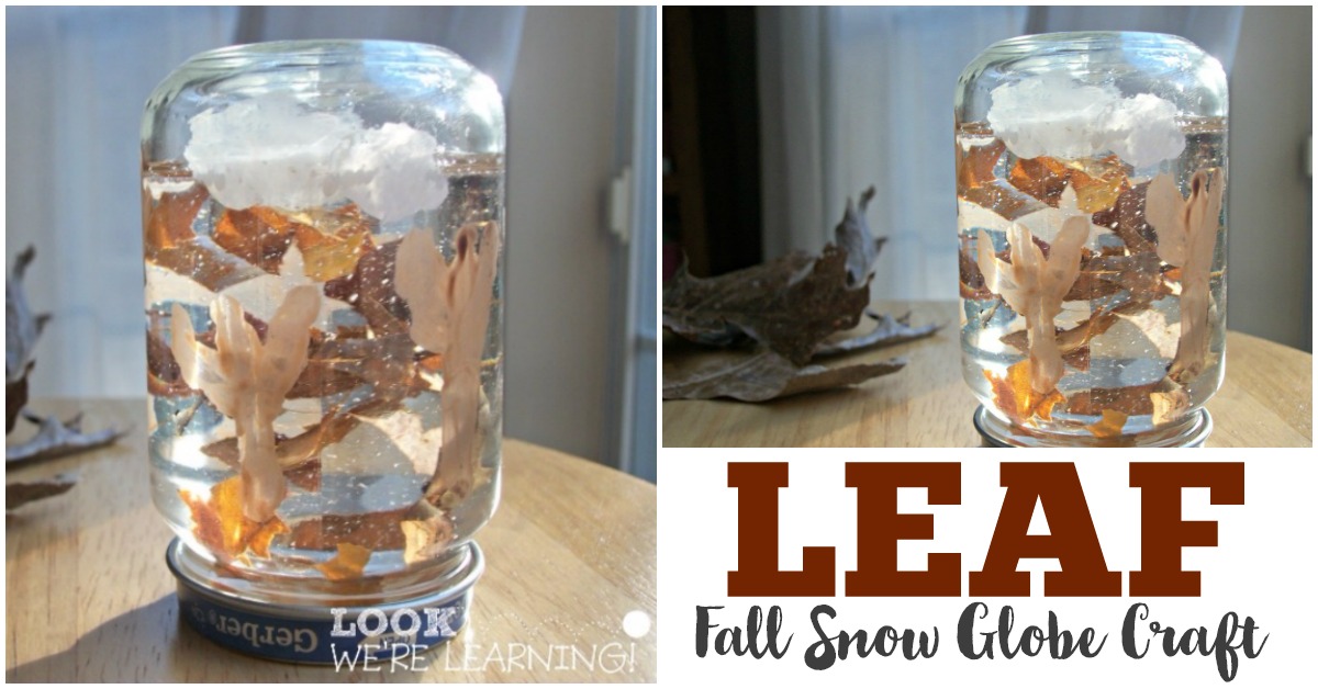 A homemade fall-themed snow globe in a jar, featuring autumn leaves and white fluffy material resembling clouds, set on a wooden surface. The text reads LEAF Fall Snow Globe Craft.