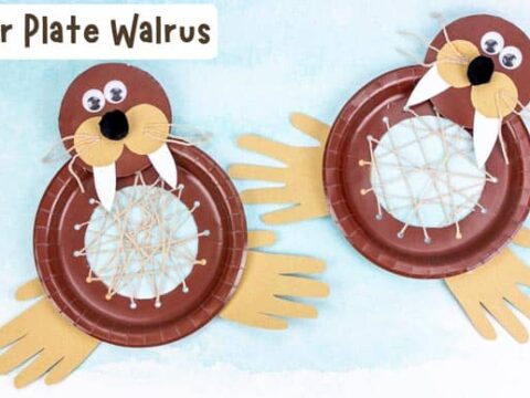 Two paper plate walruses with googly eyes, constructed using yarn, paper plates, and paper cutouts for flippers and tusks. Set against a light blue background with the text Paper Plate Walrus on top.