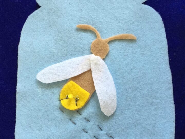 A blue felt background features a jar shape with a felt firefly inside. The firefly has electronic components for a circuit. Yellow stars are above, and the words sewn circuit are written at the top.