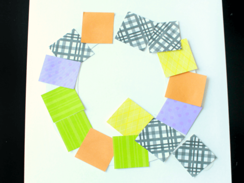 A preschool alphabet activity featuring a letter Q made with colorful patterned paper squares arranged in a circular shape on white paper. Text at the top reads Uppercase Letter Q and at the bottom preschool ALPHABET BOOK.