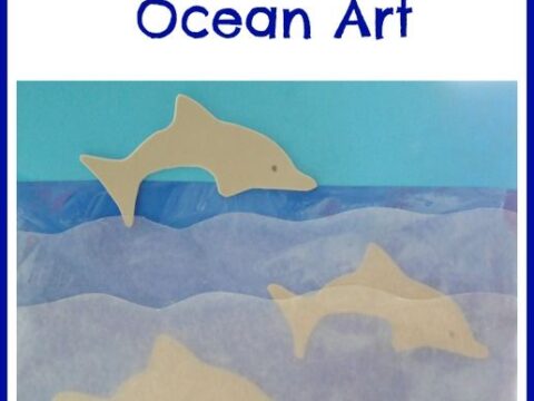 A craft project titled Dolphins in the Ocean Art features paper cutouts of dolphins set against a blue ocean-like background with waves.