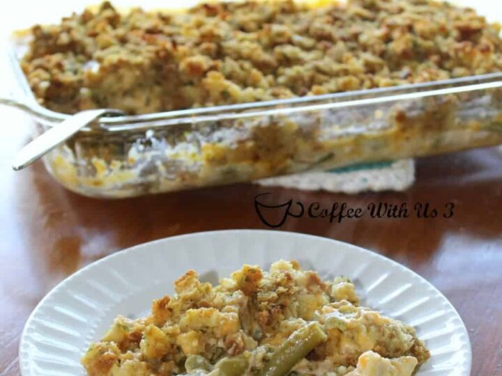 A serving of chicken green bean stuffing casserole on a white plate, with a larger dish of the casserole in the background. Text at the top reads Chicken Green Bean Stuffing Casserole, and the dish is credited to Coffee With Us 3.