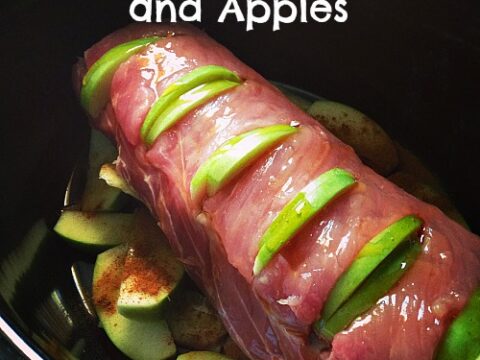 Slow cooker with a raw pork loin placed over sliced apples. The pork is slit on top, with green apple slices inserted. The text reads Crockpot Honey Pork and Apples and StockpilingMoms.com.