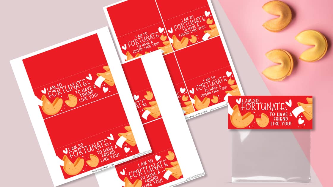 Red cards with fortune cookies and the text I am so fortunate to have a friend like you! are arranged next to a clear plastic bag and three real fortune cookies on a pink and white background.