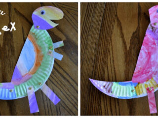 Two colorful T-Rex crafts made from paper plates are displayed. Both dinosaurs have painted bodies and paper strip tails and legs, held together with brass fasteners. The text Paper Plate T-Rex is written in the top left corner.