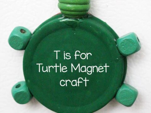 A green turtle-shaped magnet craft with T is for Turtle Magnet craft written on it. The turtle is made from a round object with small green appendages. Text above reads Preschool Letter, and below, credits Moms & Crafters for Learning 2 Walk.