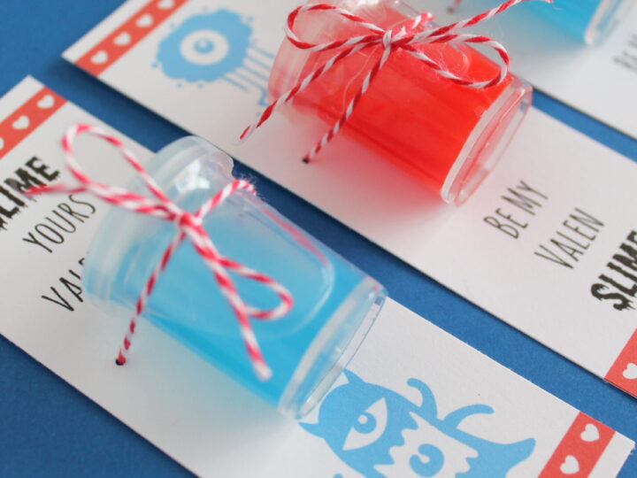 Three small jars with red and blue slime are attached to Valentines Day cards with red and white twine. The cards feature cute monster illustrations and playful text. The bottom of the image shows the website www.twindragonflydesigns.com.