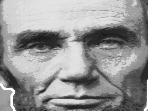 Grayscale image of a man with a somber expression, prominent cheekbones, and a beard. The image appears to be stylized with a textured, artistic effect.