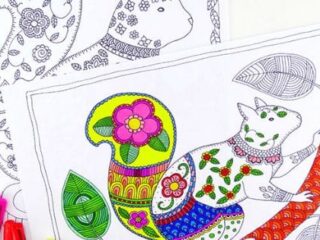 Coloring pages featuring intricately patterned animals, with one page showing a vibrant, partially colored cat-like creature sitting on a branch, decorated with flowers and geometric designs. Bright markers accompany the images.