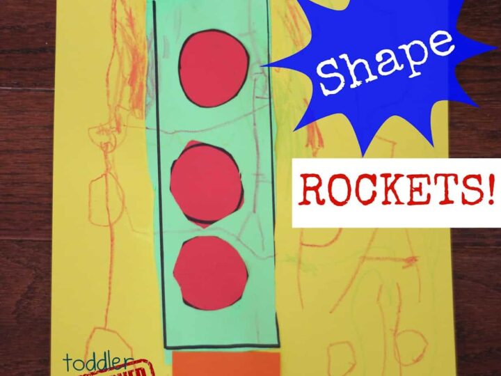 A colorful childrens craft of a rocket made with paper shapes on a yellow background. The rocket has a green body, red circles, an orange fringe, and a purple triangle top. Text reads Shape ROCKETS! and toddler APPROVED.