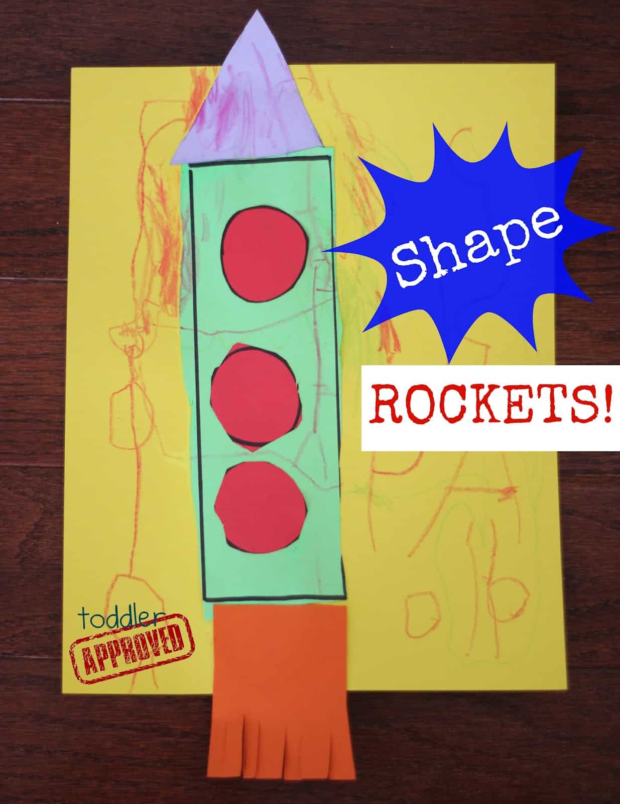 A colorful childrens craft of a rocket made with paper shapes on a yellow background. The rocket has a green body, red circles, an orange fringe, and a purple triangle top. Text reads Shape ROCKETS! and toddler APPROVED.
