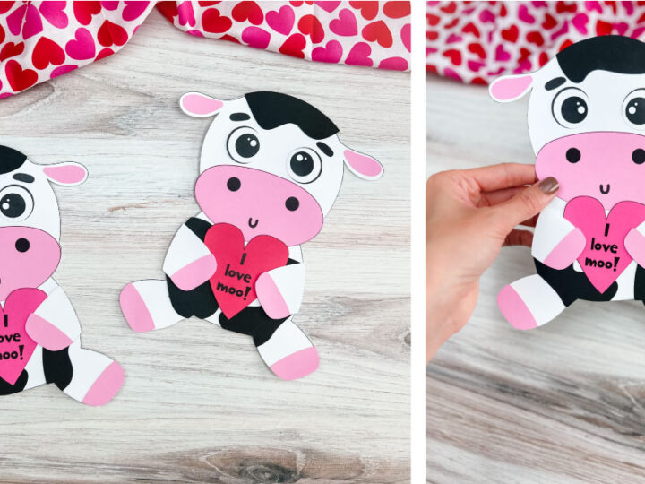 Two paper cows with pink noses and ears, each holding a red heart with I love moo! written on it, are displayed on a wooden surface. A hand holds one cow. A heart-patterned cloth partially appears in the background.