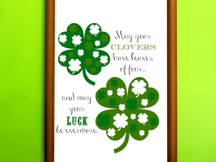 A wooden-framed picture against a bright green wall. It features three shamrocks and the text: May your clovers have leaves of four... and may your luck be evermore. The design is in various shades of green with white accents.