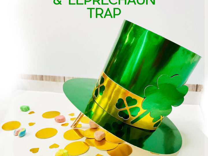 A shiny green paper top hat with a gold band, decorated with clovers, stands upright. Gold paper coins and colorful marshmallows are scattered around the hat. Text above reads, DIY Paper Hat & Leprechaun Trap.